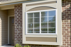 Box bay window with contrast paint and brick