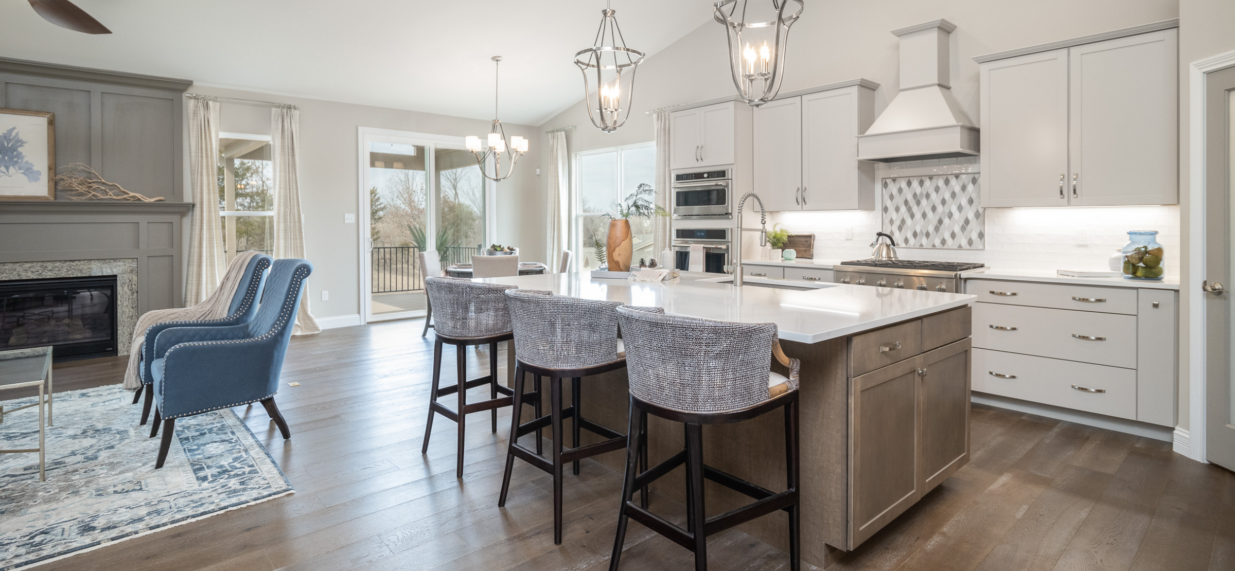 Open concept kitchen and living area with natural light and connected main-level spaces